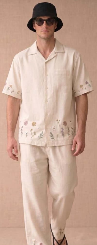 Model wearing an embroidered linen camp shirt and trousers