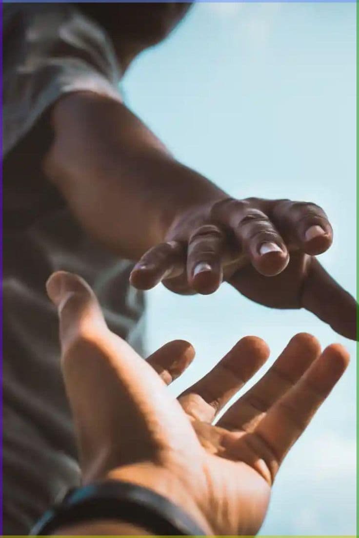 Two hands reaching towards each other
